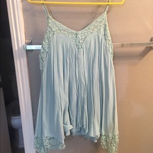Light blue spaghetti top. Top's bottom expands.